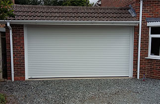 A Sws Seceuroglide Excel roller shutter garage door  with White UPVC on the inside brick faces. Fitted in Basingstoke, Hampshire. &ldquo;We are very happy with the door and the service you provided, had great fun last night making the door go up & down. We will have no hesitation in recommending you.&rdquo; Maggie and Des