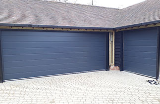 Two Carteck Centre rib style sectional garage doors in Anthracite Grey. Fitted in Chobham, Surrey.
