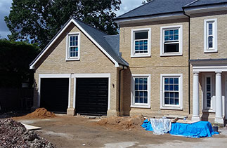 Two Carteck Georgian design sectional garage doors in Black with Black ash upvc over the door frames. Doors fitted in Ascot, Berkshire.