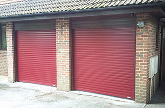 Two Gliderol Purple/Red 77mm insulated, electronically operated roller shutter garage doors. These doors were fitted so the guides and full internal boxes sit behind the existing timber frames giving full drive through width and height. Fitted in Camberley, Surrey. Hi Ben, really super pleased with the doors. A great decision in the end. Thank you and your team for the excellent customer service. Best regards, Cameron