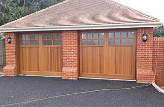 Two Woodrite Bierton style with bespoke windows, Cedar wood up and over garage doors with matching timber frames. Fitted in Waltham St Laurence. Berkshire.