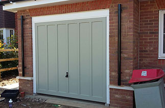 A Woodrite Churchill timber up and over garage door in a colour match to Farrow and Ball French Grey. Fitted on retractable plus door gear and with a White steel frame. Door fitted in Hartley Wintney, Hampshire.