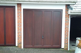 A Woodrite Standerwick up and over garage door, fully finished in Mahogany with a fully finished white Ral soft wood timber frame. Fitted in Guildford, Surrey.