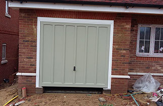 A Woodrite timber up and over garage door supplied in a colour match to Farrow & Ball French Grey. Fitted to plot 4 in Hartley Wintney, Hampshire.