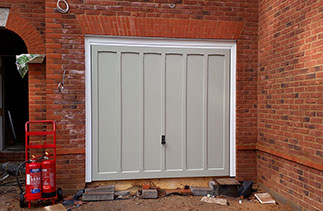 A Woodrite timber up and over garage door with a White chassis and a white steel frame. Fitted in Basingstoke, Hampshire