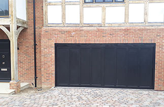 A Woodrite timber up and over garage door in the Standerwick style in Black. Fitted in Esher, Surrey.
